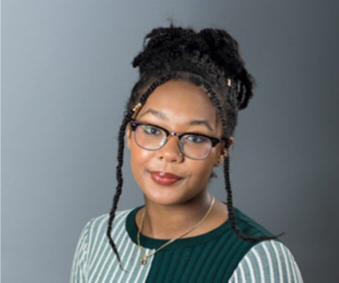 Confident legal professional with glasses and stylish hair portrait for Jackman Law Firm SEO.